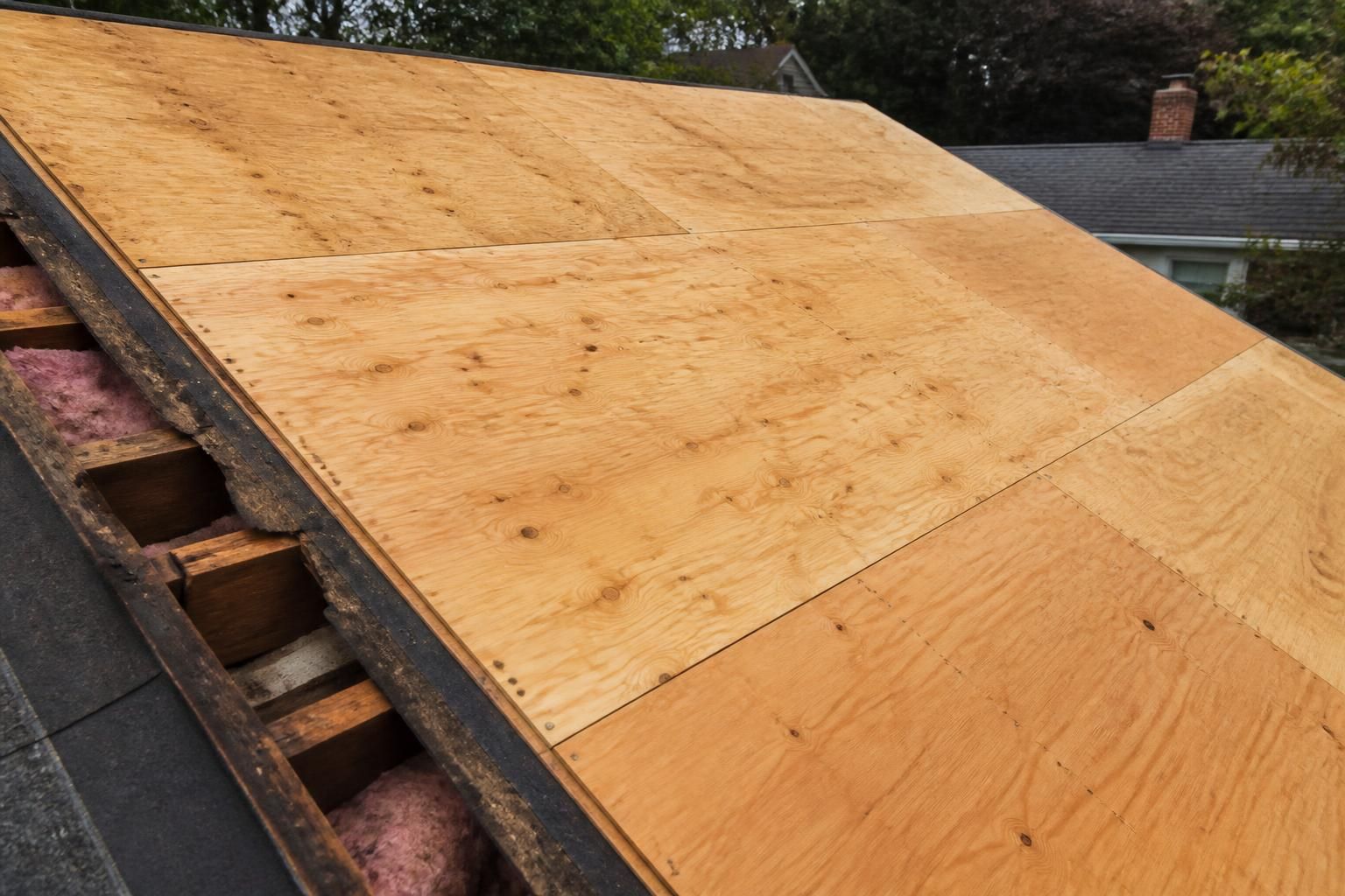 Repaired roof deck with clean plywood sheathing.